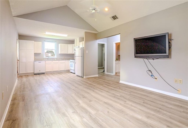 unfurnished living room featuring ceiling fan, light hardwood / wood-style floors, and vaulted ceiling