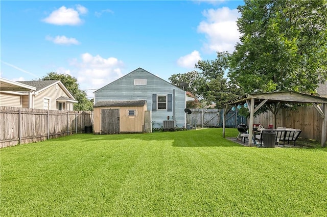 view of yard with a shed and central AC