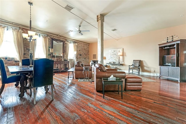 living room with radiator, ceiling fan, hardwood / wood-style flooring, and brick wall