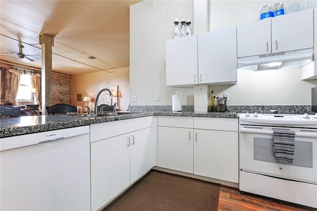 kitchen featuring white appliances, sink, dark hardwood / wood-style flooring, ceiling fan, and white cabinets