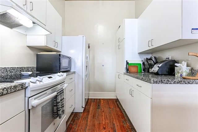 kitchen featuring white cabinets, dark hardwood / wood-style floors, white appliances, and dark stone countertops