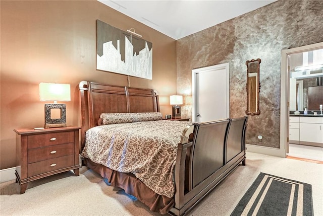 carpeted bedroom featuring ensuite bathroom