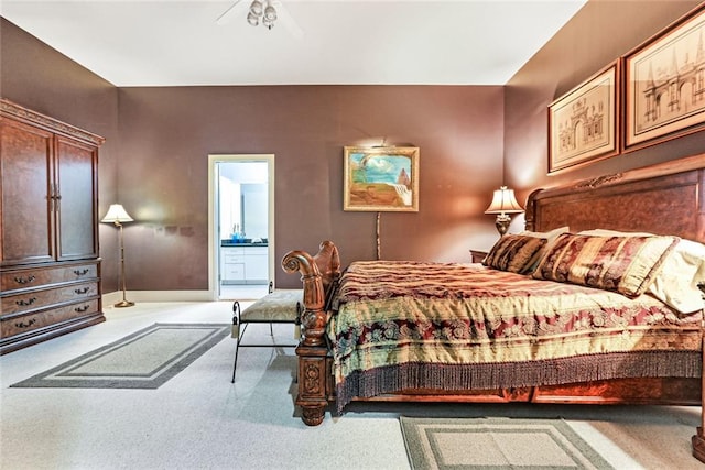 carpeted bedroom featuring connected bathroom and ceiling fan