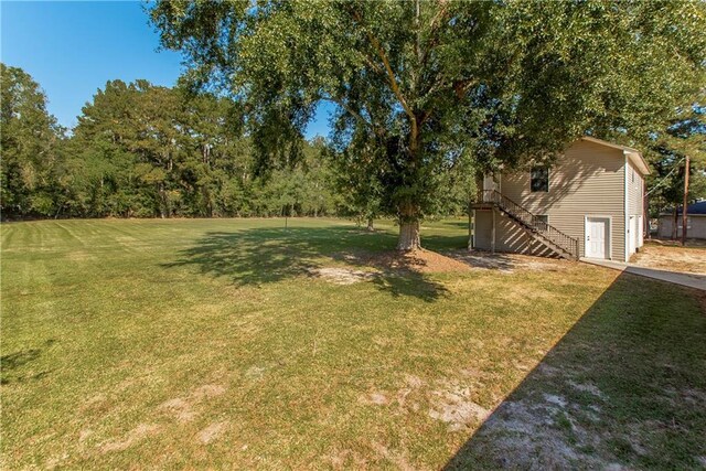 13027 Tammy Dr, Tickfaw, LA 70466 - view of grassy yard featuring stairway