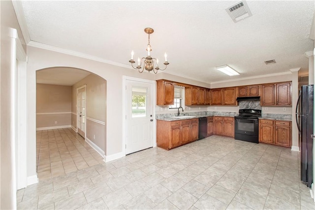 kitchen featuring crown molding, black appliances, an inviting chandelier, and pendant lighting