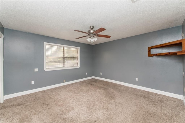 carpeted empty room featuring a textured ceiling and ceiling fan