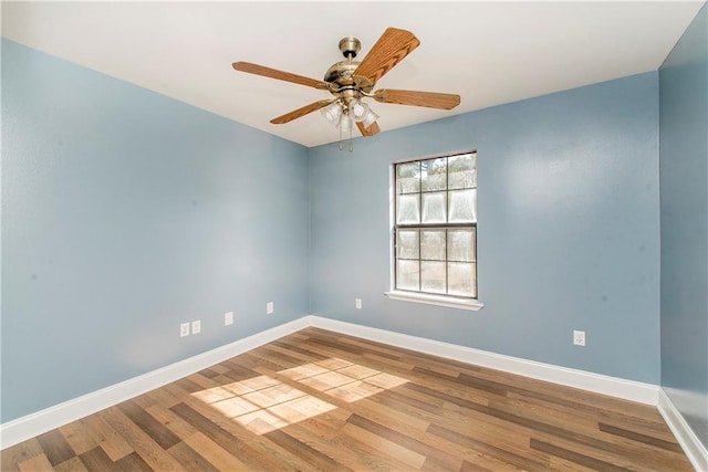 empty room with ceiling fan and wood-type flooring