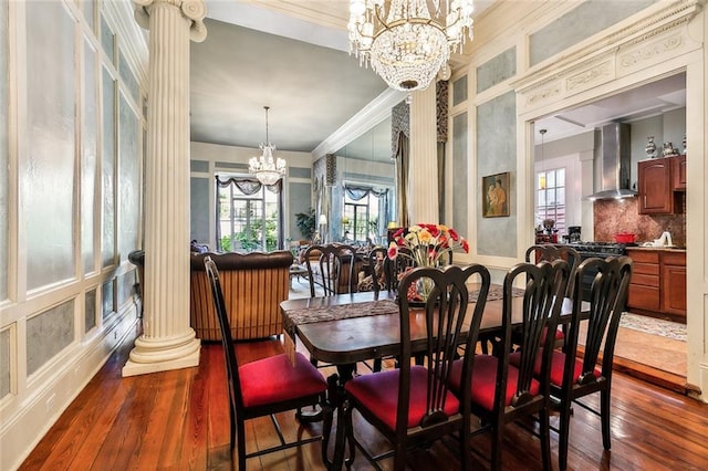 dining area with an inviting chandelier, dark wood-type flooring, and a healthy amount of sunlight