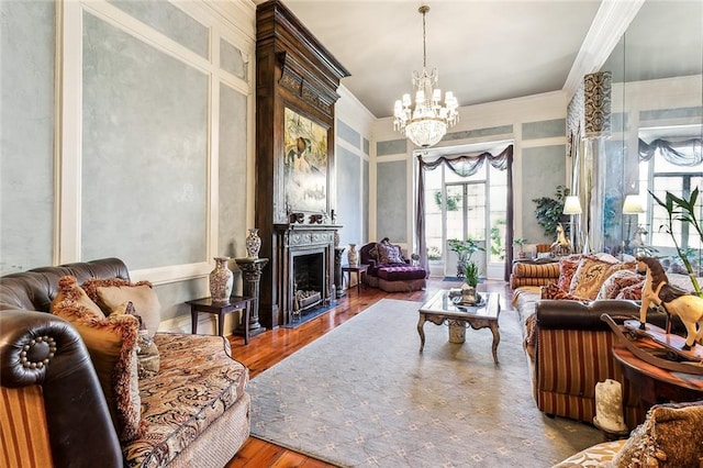 living room featuring a chandelier, crown molding, and hardwood / wood-style flooring