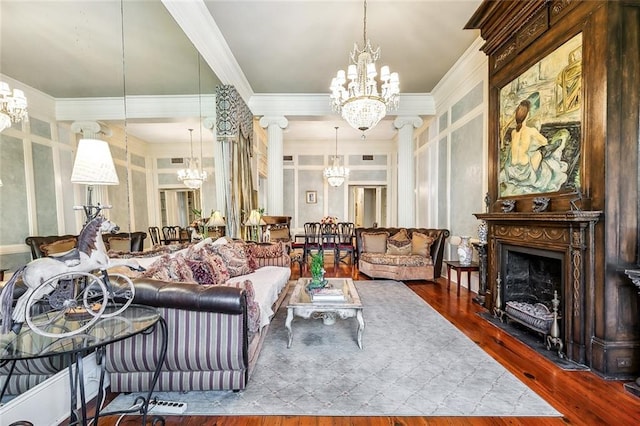 living room featuring a notable chandelier, ornamental molding, and hardwood / wood-style flooring