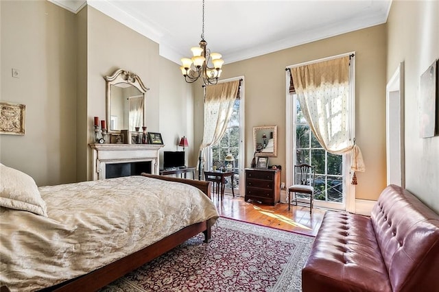 bedroom featuring crown molding, wood-type flooring, and an inviting chandelier