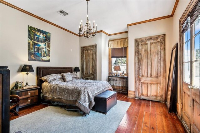 bedroom with ornamental molding, dark hardwood / wood-style floors, and an inviting chandelier