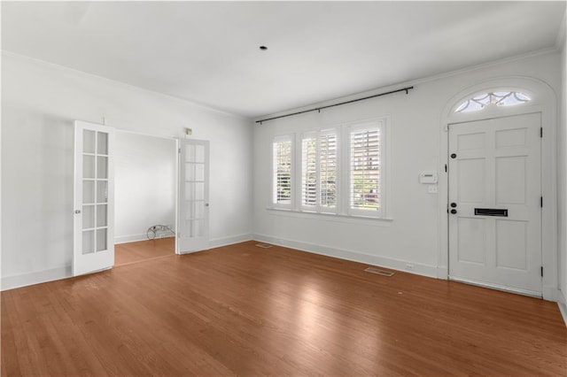 entryway with french doors, hardwood / wood-style flooring, and crown molding