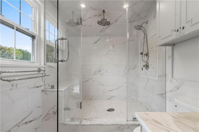 bathroom featuring tile walls and an enclosed shower