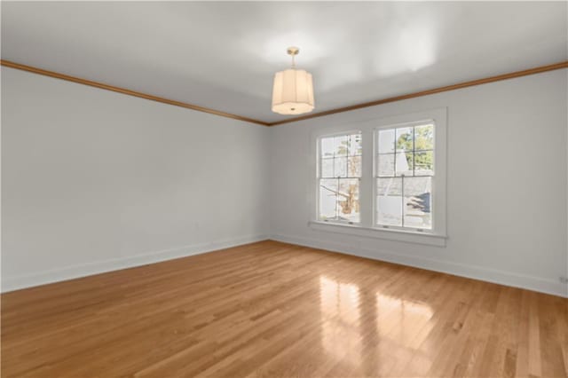 unfurnished room featuring light hardwood / wood-style floors and crown molding