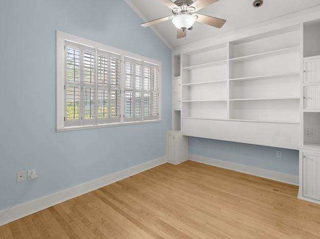 spare room with crown molding, vaulted ceiling, ceiling fan, and light hardwood / wood-style flooring