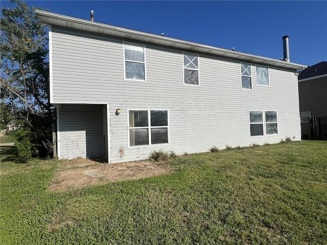 rear view of property with a lawn