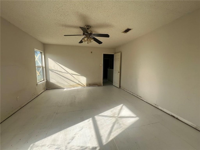 spare room featuring a textured ceiling and ceiling fan