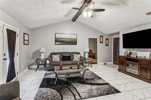 living room with ceiling fan, lofted ceiling with beams, and a textured ceiling