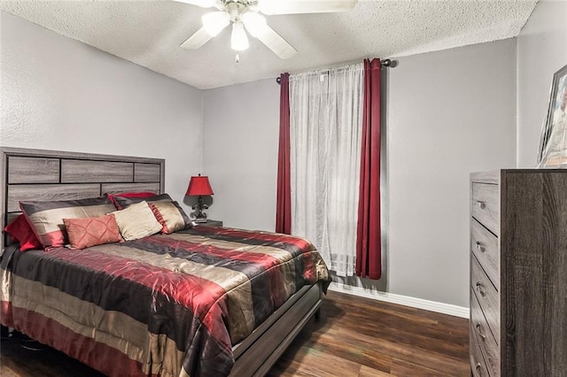 bedroom featuring a textured ceiling, ceiling fan, and dark hardwood / wood-style flooring