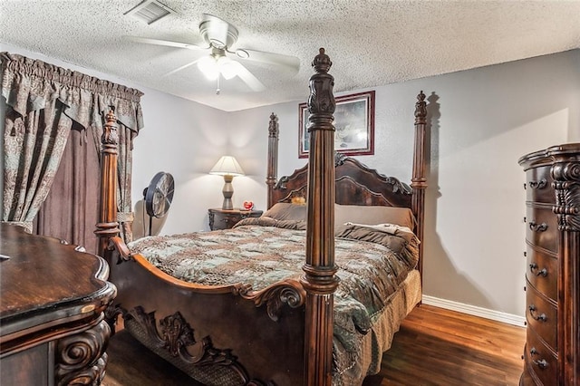 bedroom featuring dark hardwood / wood-style flooring, a textured ceiling, and ceiling fan