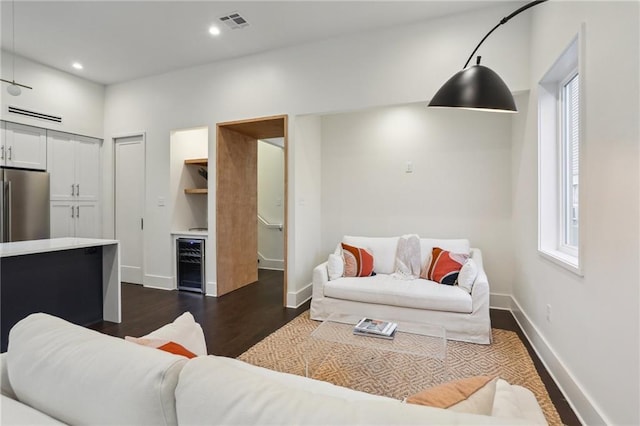 living room featuring a wealth of natural light, dark hardwood / wood-style floors, and wine cooler