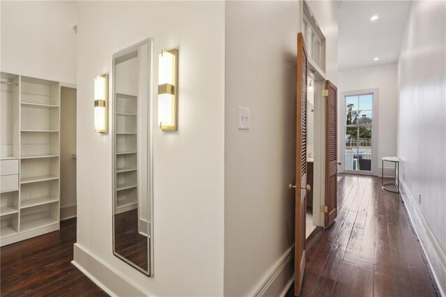 hallway with dark hardwood / wood-style flooring