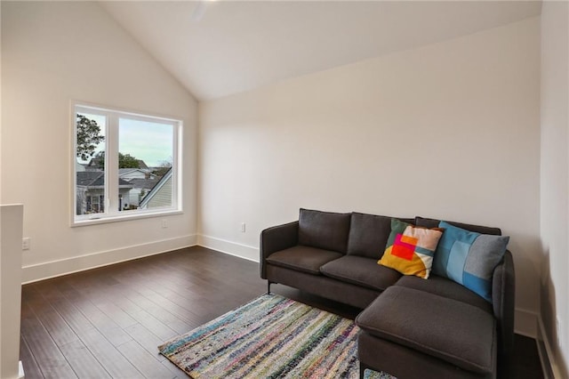 living room with dark hardwood / wood-style floors and vaulted ceiling