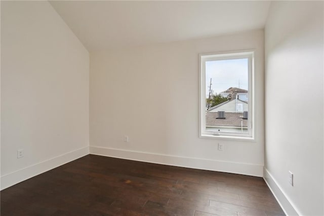 unfurnished room featuring dark hardwood / wood-style flooring