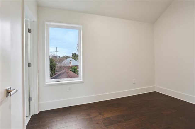 unfurnished room with dark wood-type flooring