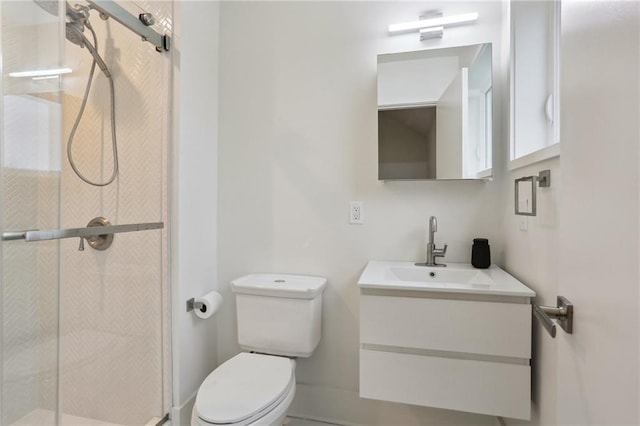 bathroom with a shower with shower door, toilet, and vanity