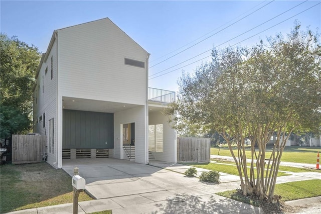 view of front of house with a carport and a balcony