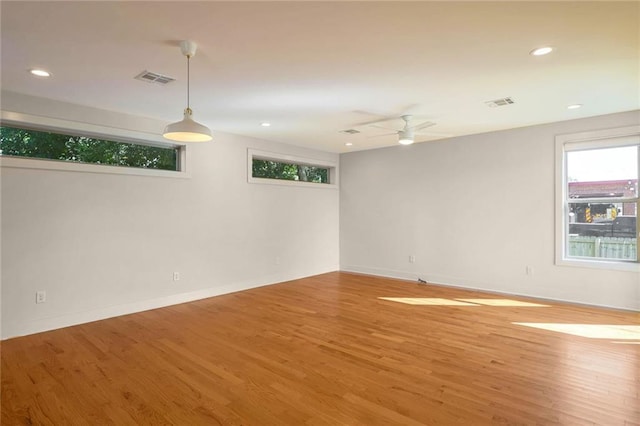 unfurnished room with hardwood / wood-style flooring and ceiling fan