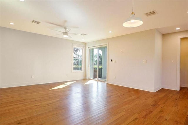 spare room featuring wood-type flooring and ceiling fan