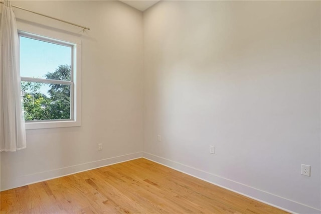 spare room featuring wood-type flooring