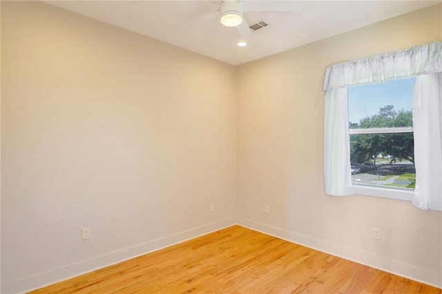 unfurnished room with hardwood / wood-style flooring and ceiling fan