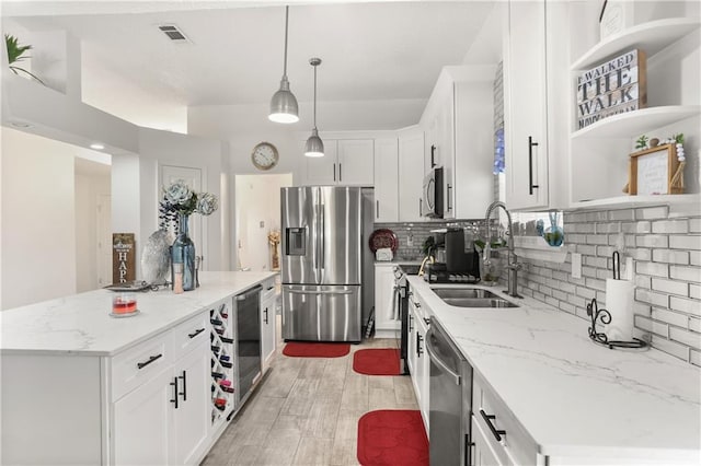 kitchen featuring stainless steel appliances, a center island, and white cabinets