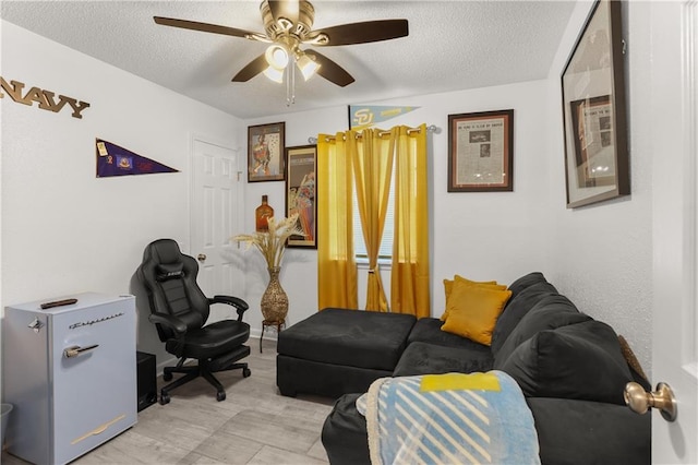 office area with a textured ceiling and ceiling fan