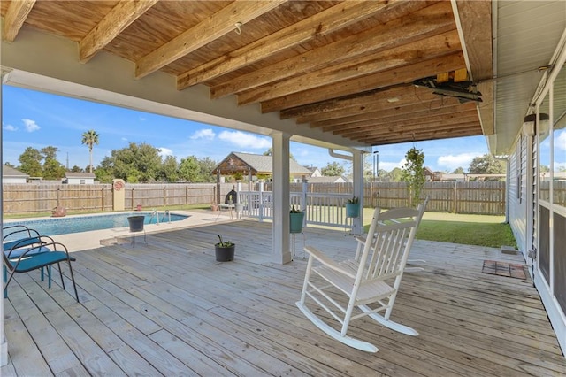 wooden deck featuring a fenced in pool