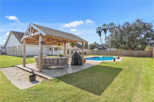 view of yard with a patio, a gazebo, ceiling fan, a fenced in pool, and central air condition unit