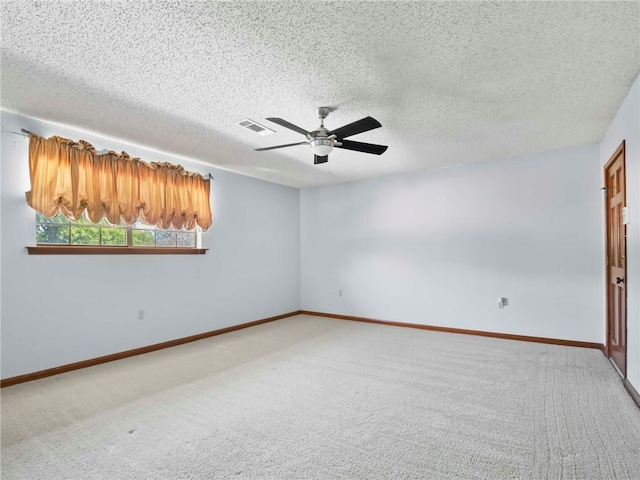 empty room featuring carpet, a textured ceiling, and ceiling fan