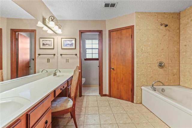 full bathroom featuring toilet, tile patterned flooring, independent shower and bath, vanity, and a textured ceiling