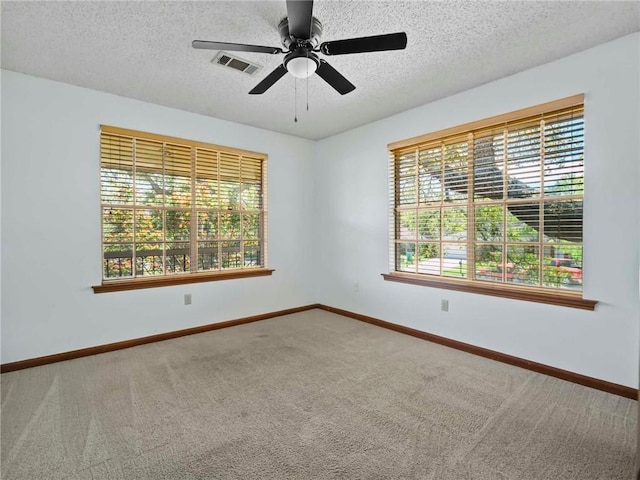 carpeted empty room featuring a textured ceiling and ceiling fan