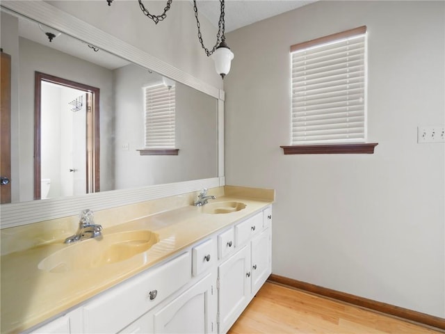 bathroom with vanity, hardwood / wood-style floors, and toilet