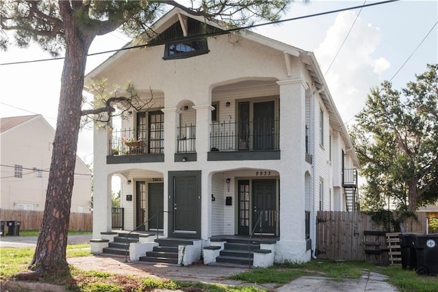 view of front of home featuring a balcony and a porch