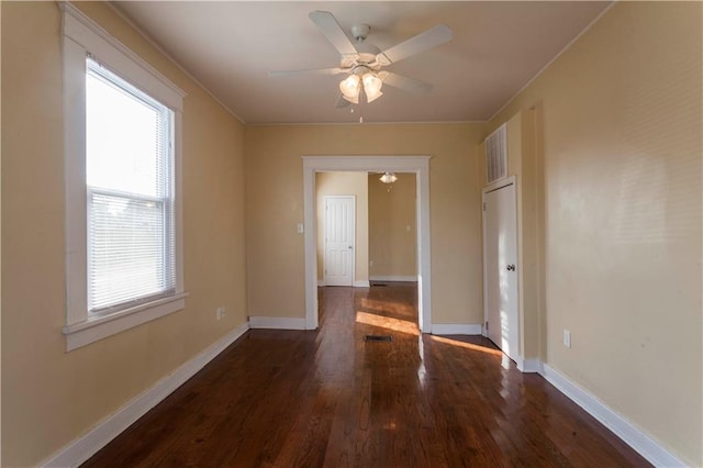 spare room with dark hardwood / wood-style floors and ceiling fan