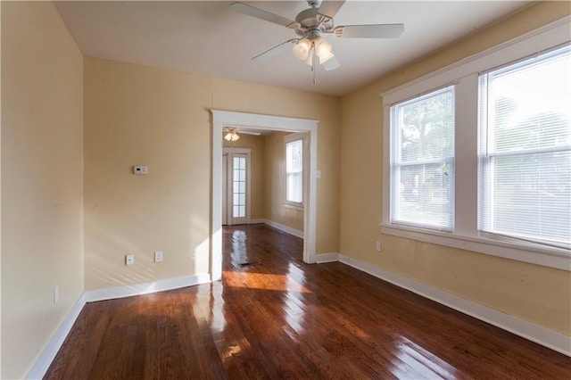 spare room featuring ceiling fan and dark wood-type flooring