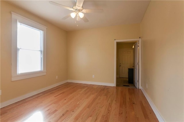 unfurnished room with ceiling fan and light wood-type flooring