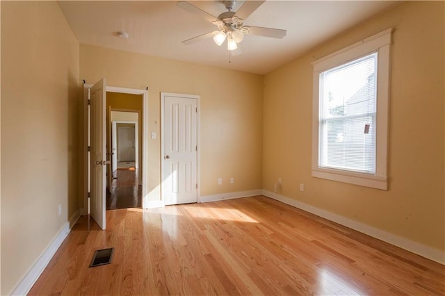 spare room with ceiling fan and light hardwood / wood-style floors