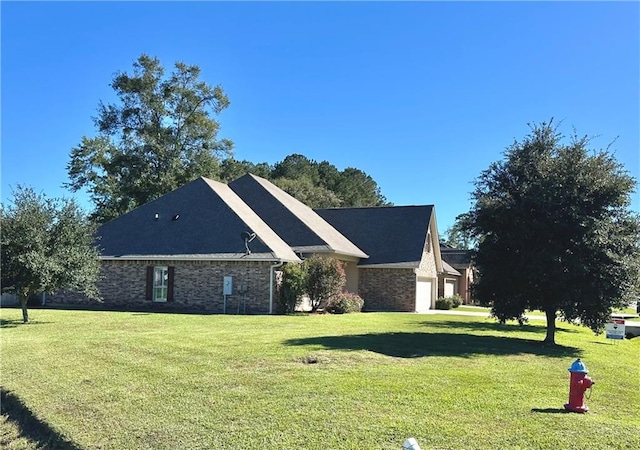 view of side of property with a lawn and a garage